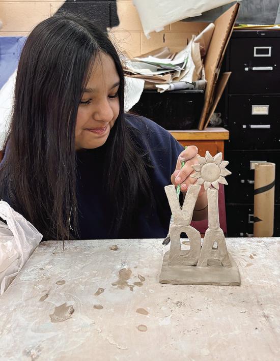 Omelda Lovos works on her clay miniature word sculpture at Clinton High School. Her class made them as a tribute to Robert Indiana’s Love sculpture. CDN | Courtesy photo Omelda Lovos works on her clay miniature word sculpture at Clinton High School. Her class made them as a tribute to Robert Indiana’s Love sculpture. CDN | Courtesy photo