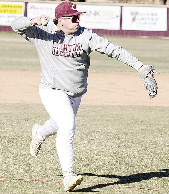 CDN | Sam Goodwyn Clinton’s Trason Lustfield hurls the ball to first for the out during practice at the baseball field.