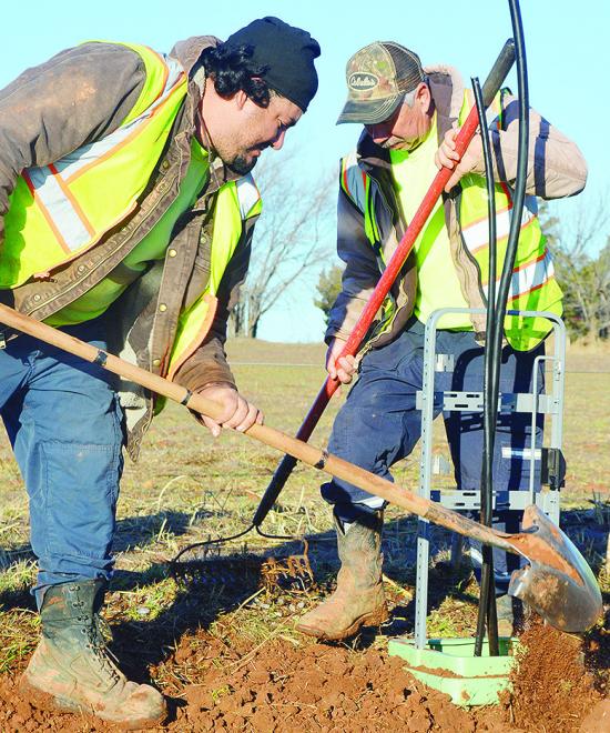 Michael Castillo, left, and Rancho Rodriguez replace and smooth out the dirt after excavating near a utility pole for maintenance Thursday morning on S. 28th Street. CDN | Micah Ashcraft