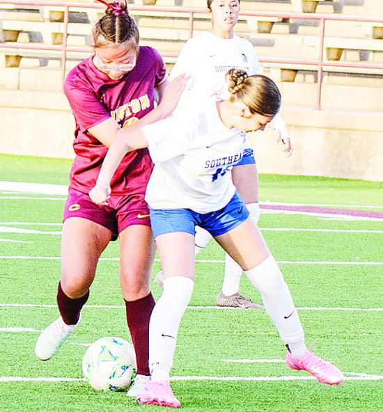 Clinton’s Leila Pete, left, fights through a Southeast defender during the Lady Reds’ home win over the Lady Spartans. CDN | Sam Goodwyn Clinton’s Leila Pete, left, fights through a Southeast defender during the Lady Reds’ home win over the Lady Spartans. CDN | Sam Goodwyn