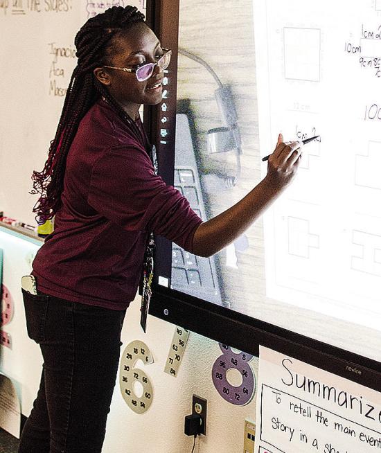 Jessica Jefferson writes on the smart board as she teaches math during school at Southwest Elementary School. CDN | Sam Goodwyn Jessica Jefferson writes on the smart board as she teaches math during school at Southwest Elementary School. CDN | Sam Goodwyn