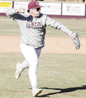 CDN | Sam Goodwyn Clinton’s Trason Lustfield hurls the ball to first for the out during practice at the baseball field.