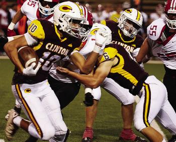 Clinton’s JJ Ruiz, left, carries the ball downfield while No. 6 Benton Bridgeman and Brayden Fuller provide blocks during the Red Tornadoes’ homecoming game Friday against Elgin in the Tornado Bowl. CDN | Micah Ashcraft